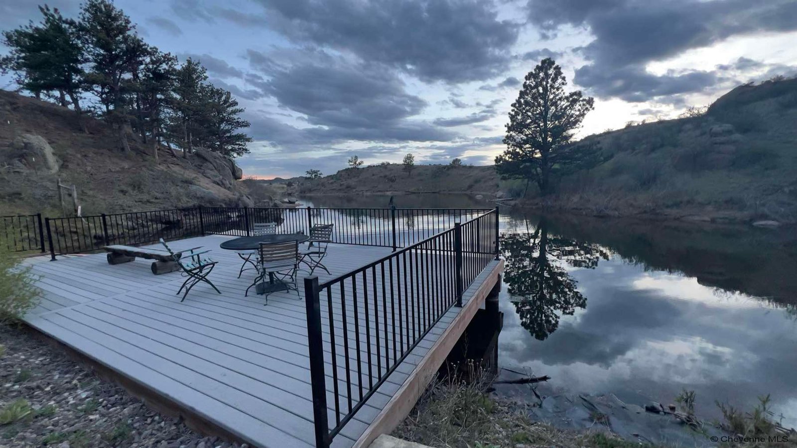 The private dock deck on the reservoir under evening cloud